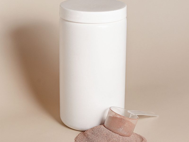 Tub of whey protein with a scoop